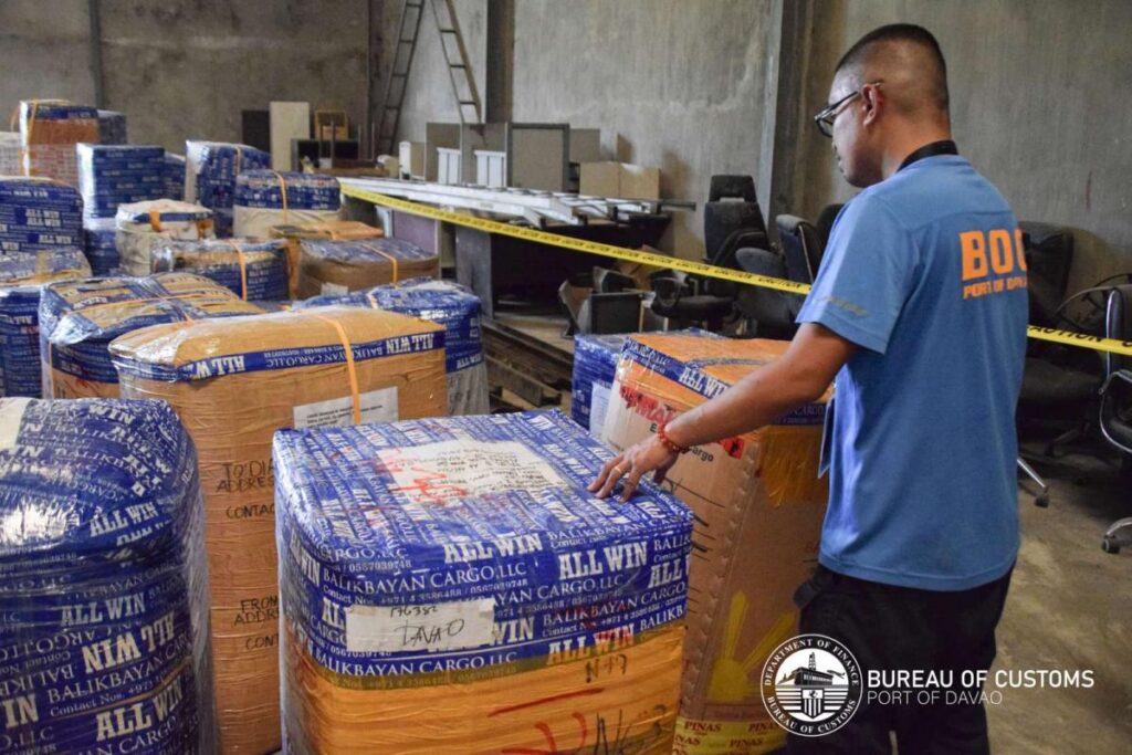 a man in a warehouse with large boxes