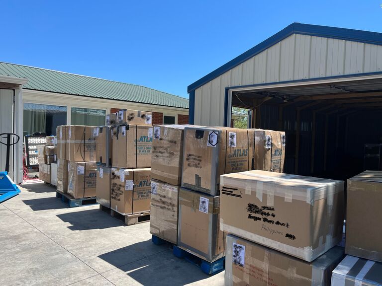 boxes on pallets outside a building